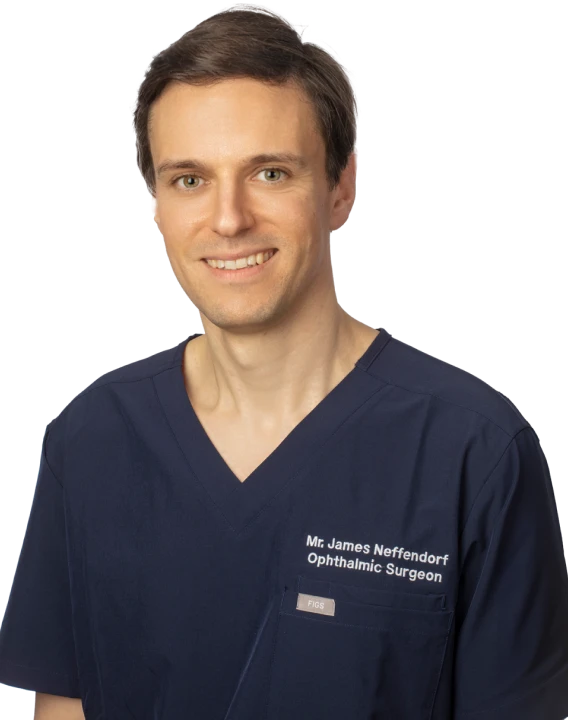 Mr James E. Neffendorf, Ophthalmic Surgeon, wearing a navy blue medical uniform and smiling.
